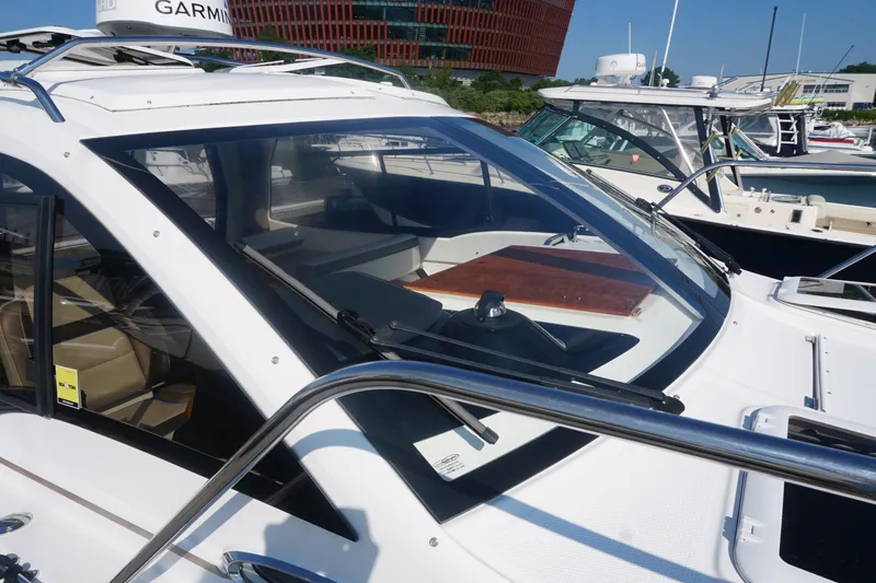 Slide: The Image of 2018 Cutwater C-24 boat docked, featuring sleek design and modern navigation equipment. - 19