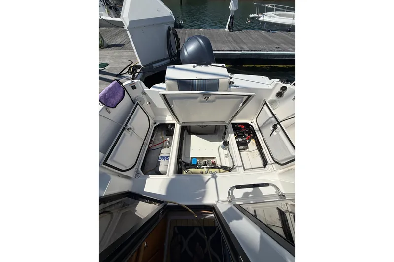 Slide: The Image of 2018 Cutwater C-24 boat interior with open storage compartments at dock. - 11