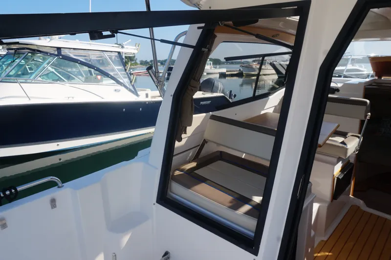 Slide: The Image of 2018 Cutwater C-24 boat interior with seating, docked beside another vessel. - 34