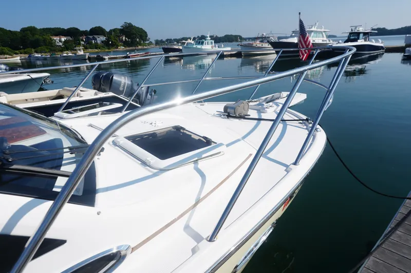 Slide: The Image of 2018 Cutwater C-24 boat docked in a marina, featuring sleek design and American flag. - 16