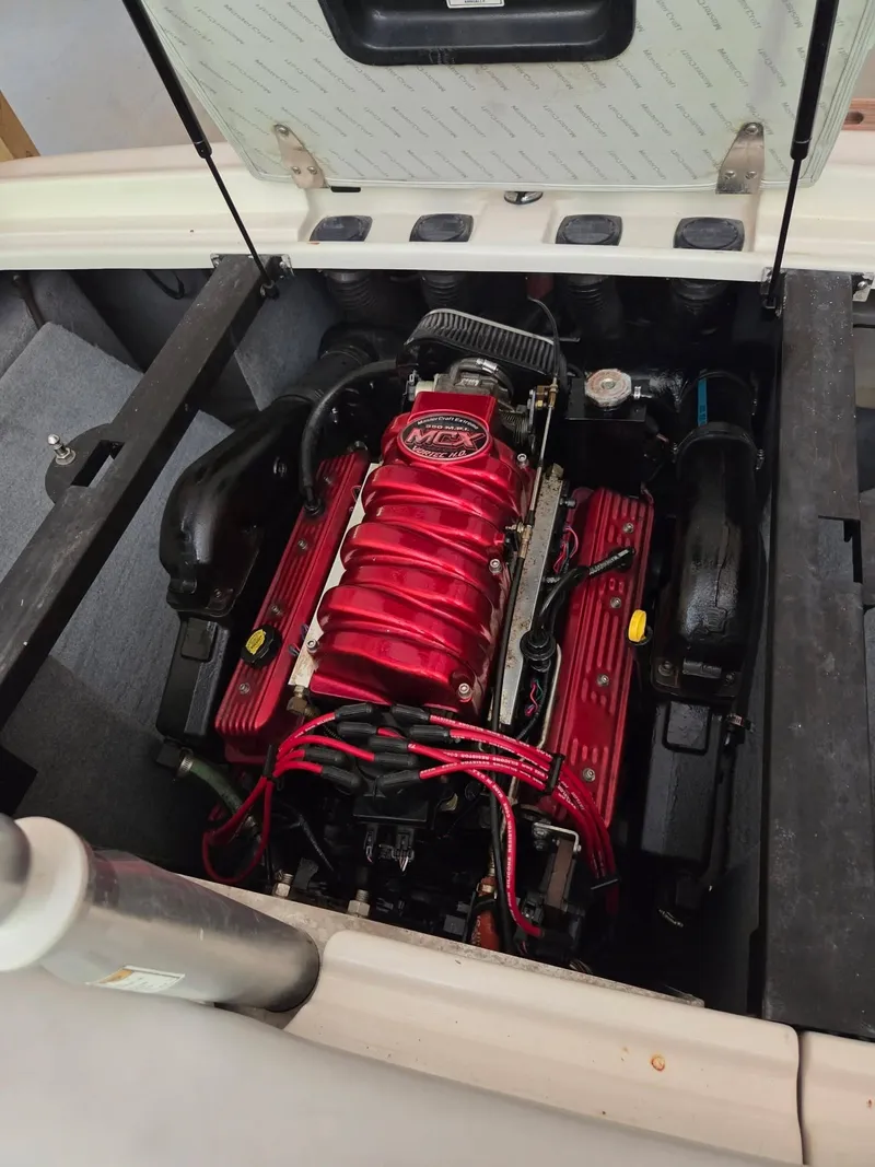 Slide: The Image of The engine compartment of a 2003 MasterCraft X-30 with a red engine block. - 8