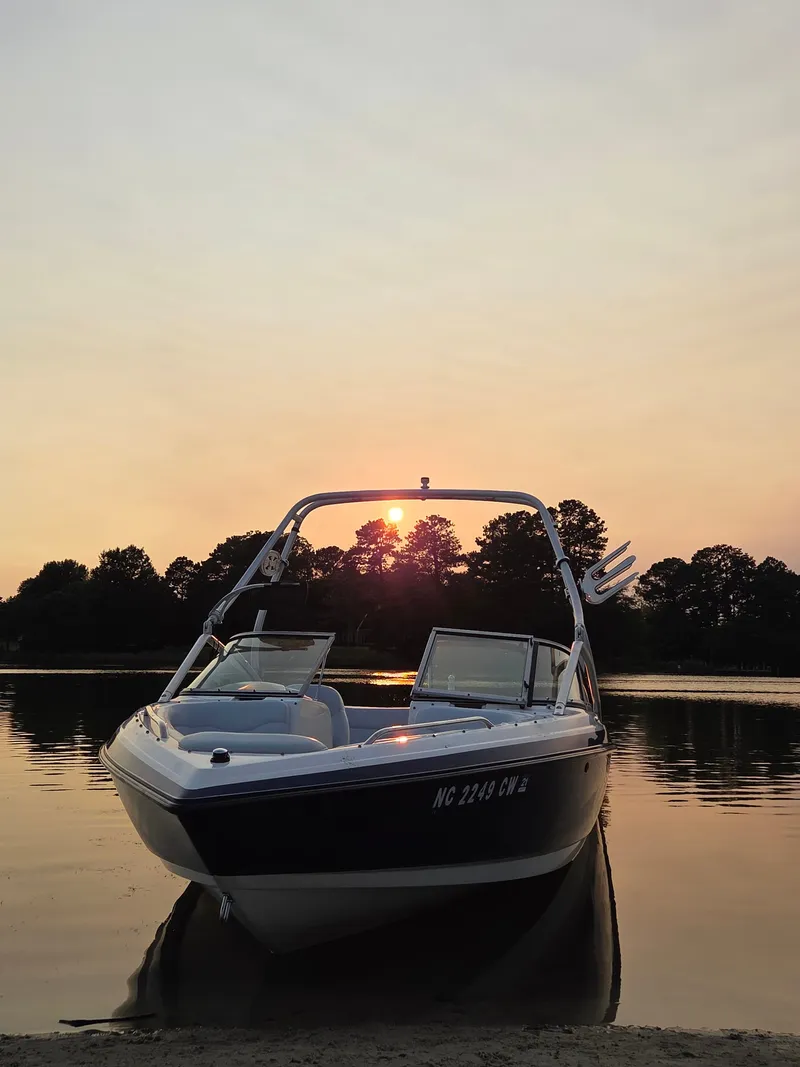 Slide: The Image of A 2003 MasterCraft X-30 rests calmly by a lake shore at sunset. - 2