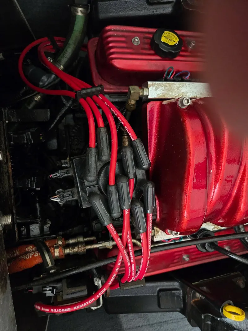 Slide: The Image of Close-up of a red boat engine with cables and hoses. - 9
