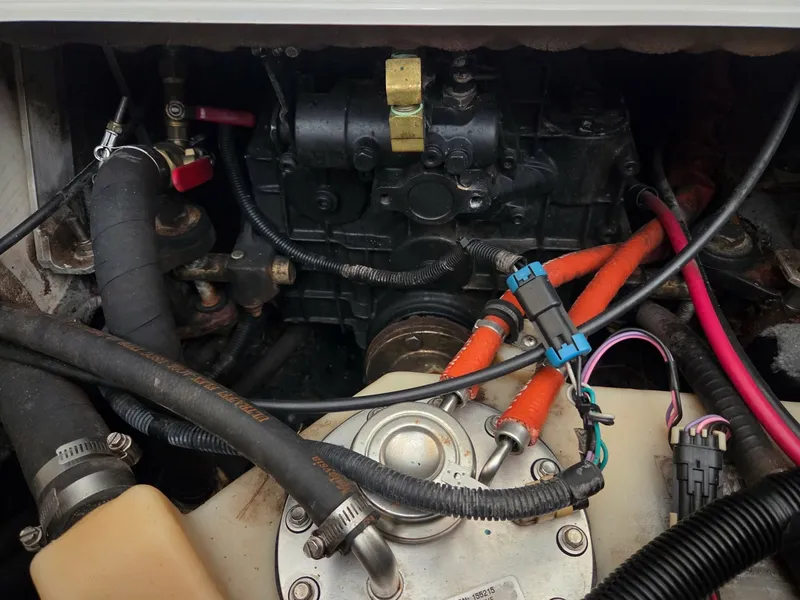 Slide: The Image of Close-up of an engine compartment with various hoses and wires. - 10