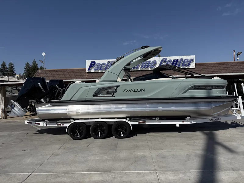 The Image of An Avalon 25' Excalibur Carbon Series boat with twin 425HP Mercury V10 engines on a trailer. - 1