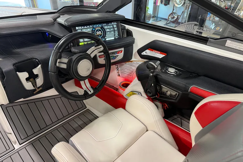 Slide: The Image of Interior of 2019 Nautique Super Air Nautique G25 boat with modern dashboard and steering wheel. - 41