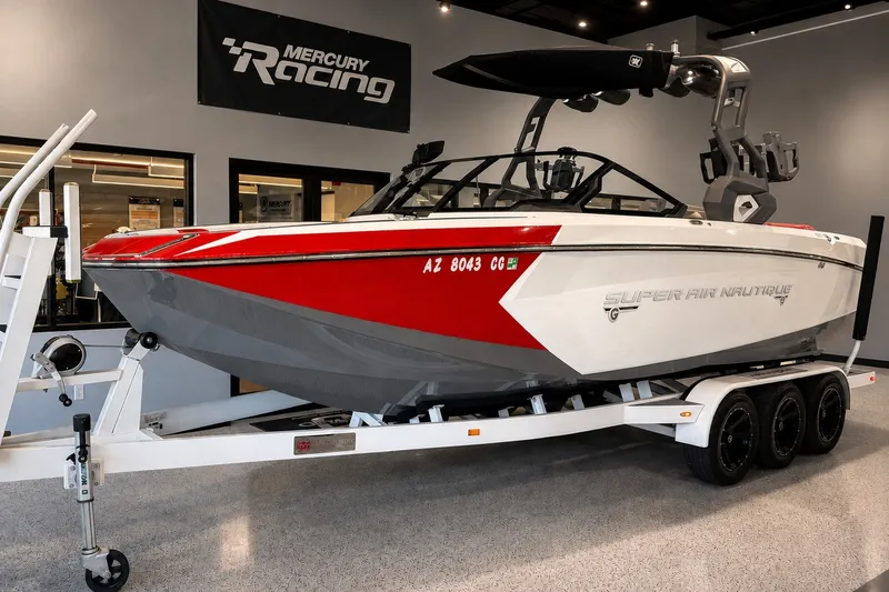 The Image of 2019 Nautique Super Air Nautique G25 boat on trailer in showroom. - 1