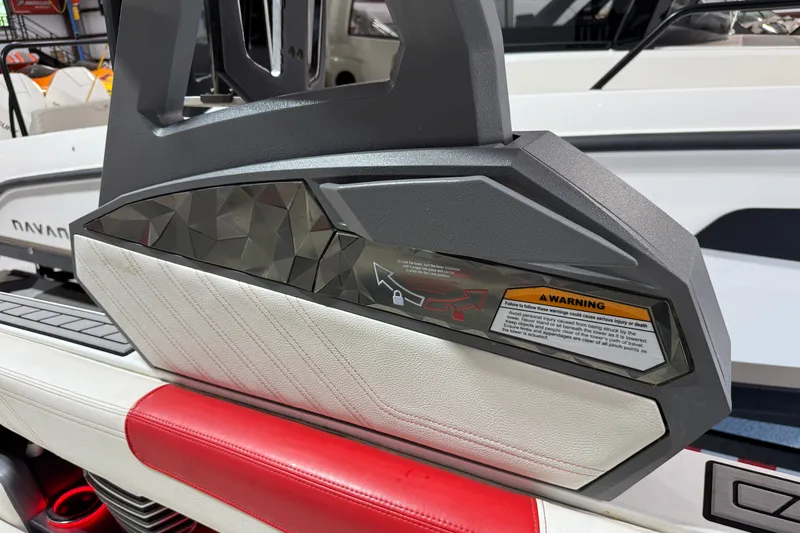 Slide: The Image of 2019 Nautique Super Air Nautique G25 interior detail with warning label and geometric design. - 29
