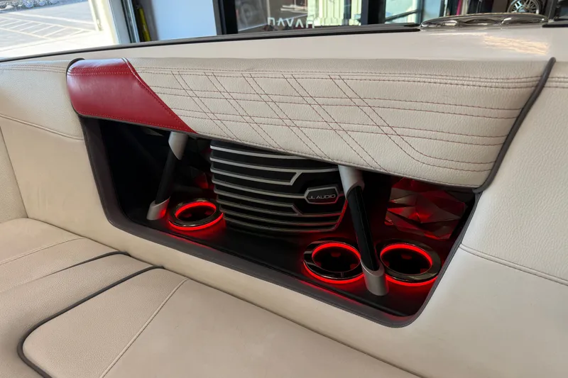 Slide: The Image of 2019 Nautique Super Air Nautique G25 interior with JL Audio system and illuminated cup holders. - 44