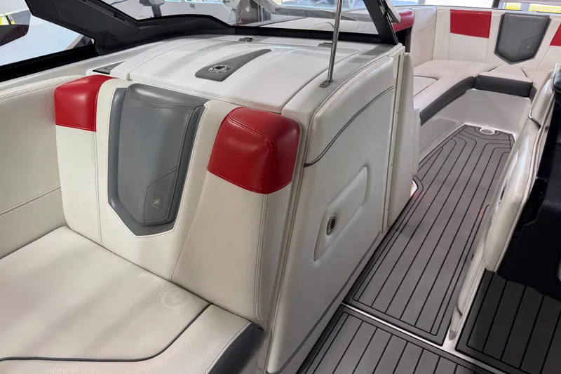 Slide: The Image of 2019 Nautique Super Air Nautique G25 interior with red and gray accents, featuring sleek seating. - 38