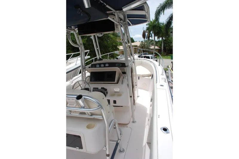 Slide: The Image of 2003 Grady-White Chase 273 boat interior with steering console and seating area. - 13