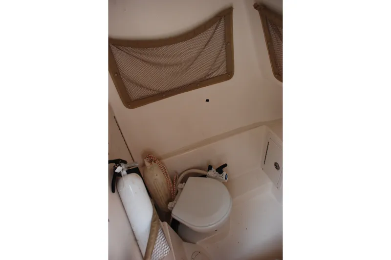 Slide: The Image of Interior of 2003 Grady-White Chase 273 boat featuring compact marine toilet. - 10