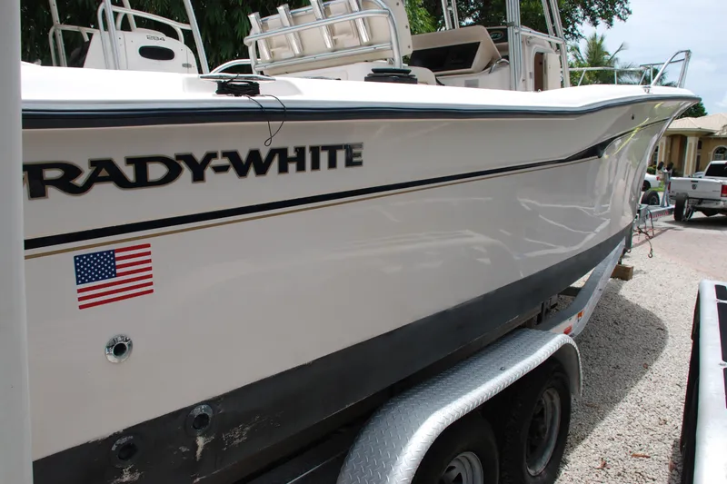 Slide: The Image of 2003 Grady-White Chase 273 boat on trailer, side view with American flag decal. - 19