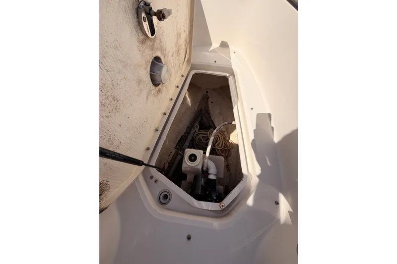 Slide: The Image of Storage compartment of a 2005 Sea Ray 240 Sundeck boat, showing ropes and equipment. - 17