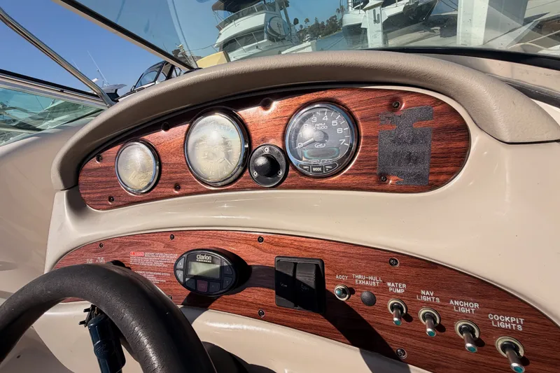 Slide: The Image of Dashboard of a 2005 Sea Ray 240 Sundeck boat with gauges and controls. - 33