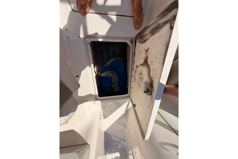 Slide: The Image of Open storage compartment on a 2005 Sea Ray 240 Sundeck boat. - 35