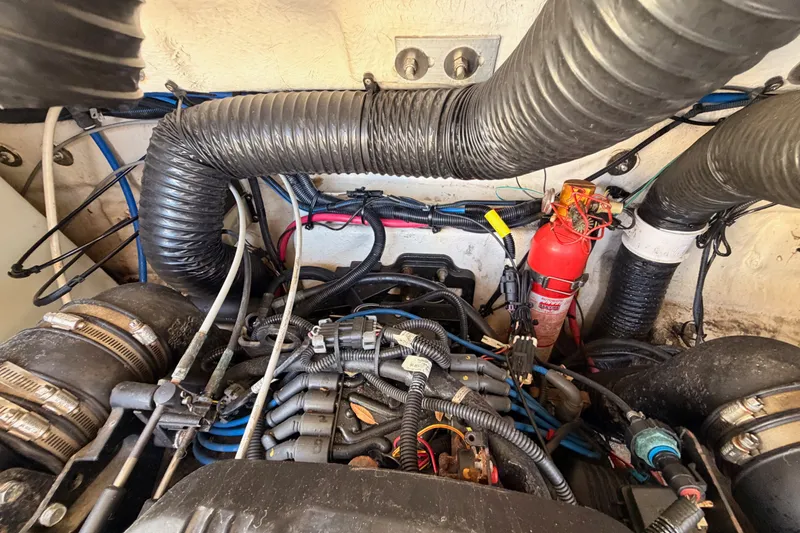 Slide: The Image of Engine compartment of a 2005 Sea Ray 240 Sundeck with visible wiring and fire extinguisher. - 32
