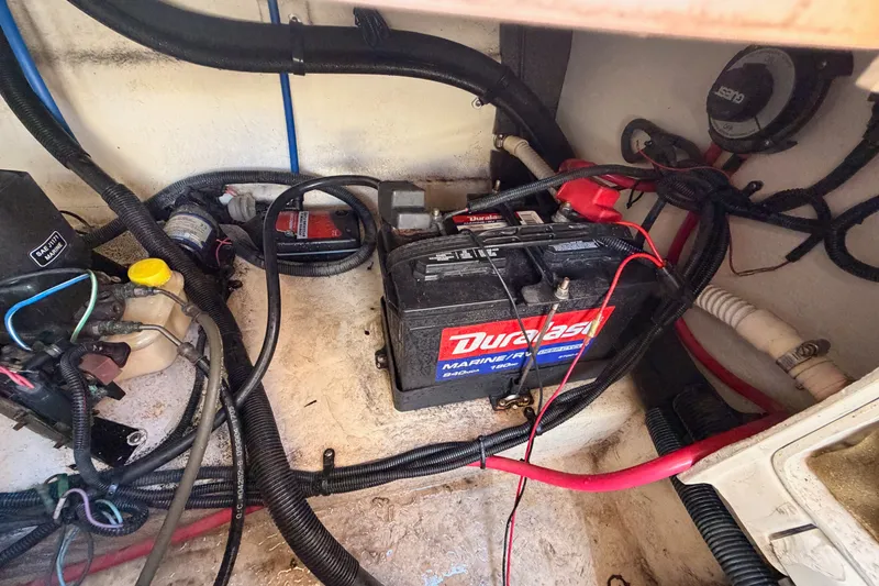 Slide: The Image of Battery compartment of a 2005 Sea Ray 240 Sundeck with wiring and components. - 30