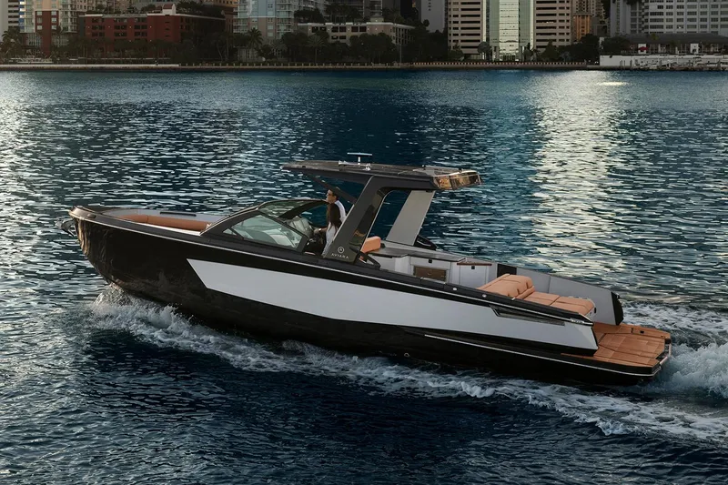 Slide: The Image of Manufacturer Provided Image: 2024 Aviara AV32 I/O luxury boat cruising on water near city skyline. - 5