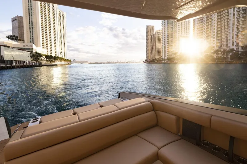 Slide: The Image of Manufacturer Provided Image: 2024 Aviara AV32 I/O luxury boat with cityscape and sunset view. - 10