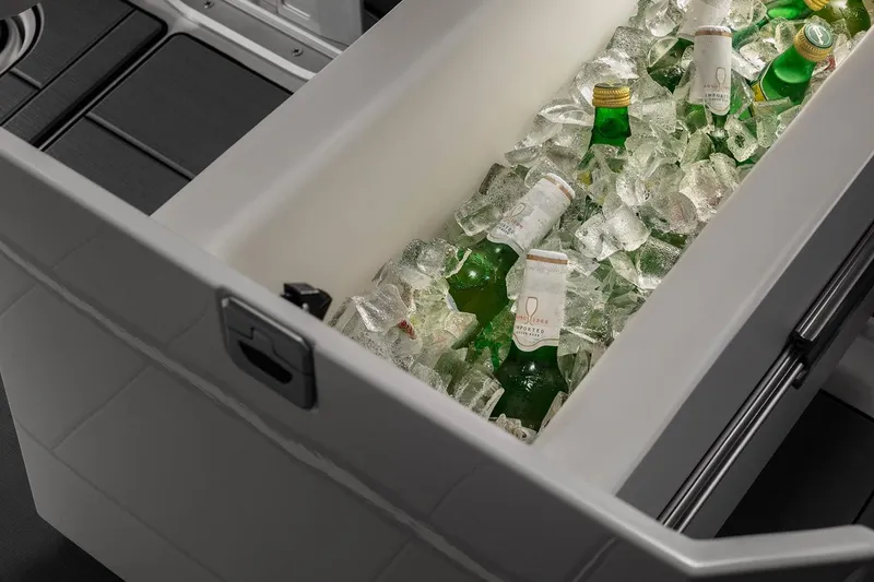 Slide: The Image of Manufacturer Provided Image: Built-in cooler with drinks and ice on the 2024 Aviara AV32 I/O boat. - 16