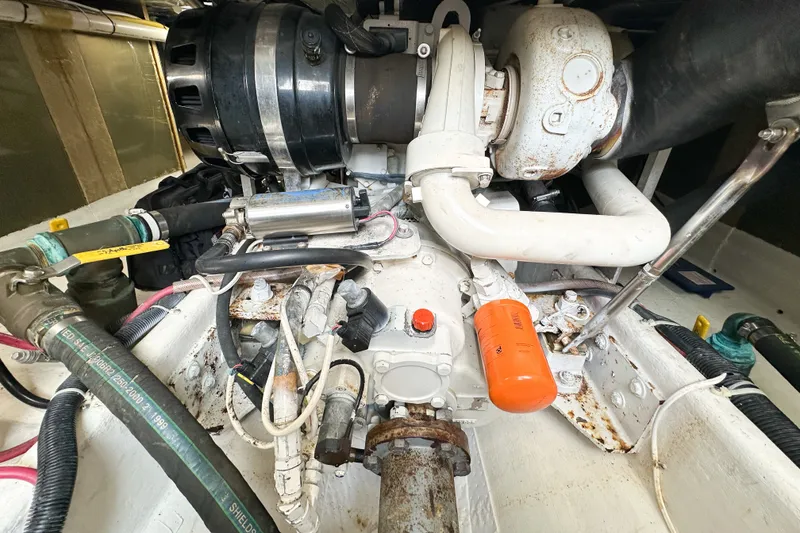 Slide: The Image of Engine compartment of a 2003 Northern Bay 36 boat, showing mechanical components and hoses. - 58