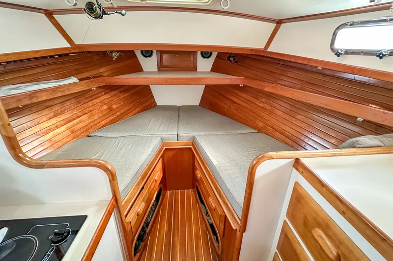 Slide: The Image of Interior of 2003 Northern Bay 36 boat with wooden finish and cozy sleeping area. - 51