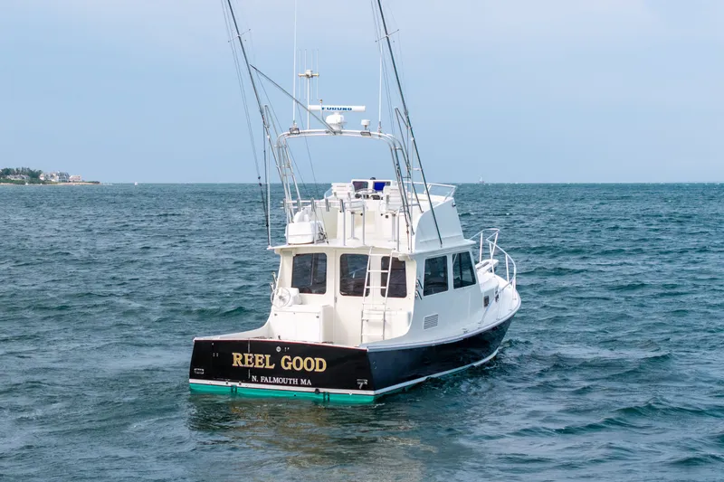 Slide: The Image of Northern Bay 36 boat from 2003 on open water, named "Reel Good." - 69