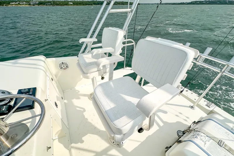 Slide: The Image of Captain's chairs on 2003 Northern Bay 36 boat, overlooking ocean waters. - 27