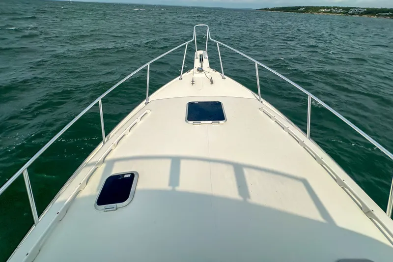 Slide: The Image of Bow view of 2003 Northern Bay 36 boat cruising on open water. - 33