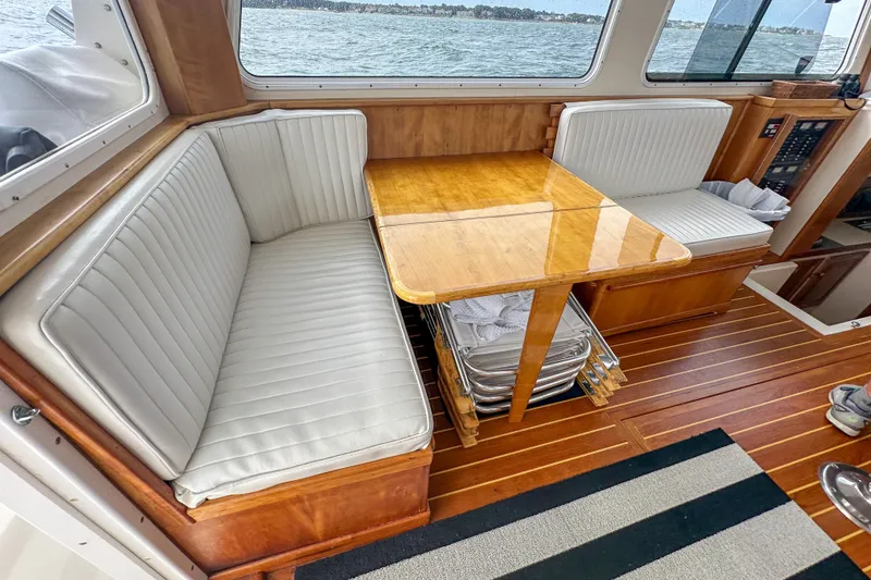 Slide: The Image of Interior of 2003 Northern Bay 36 boat with wooden table and cushioned seating. - 35