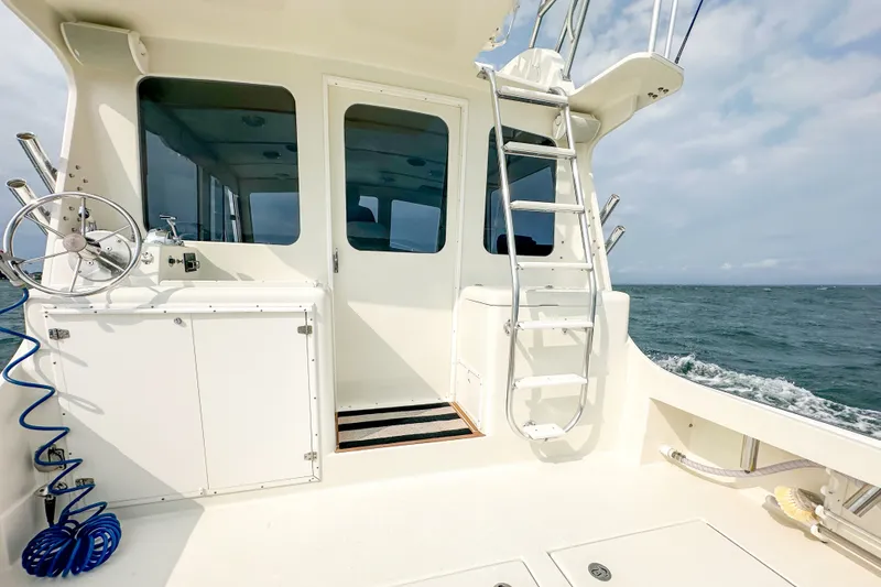 Slide: The Image of 2003 Northern Bay 36 boat deck with ladder and ocean view. - 16