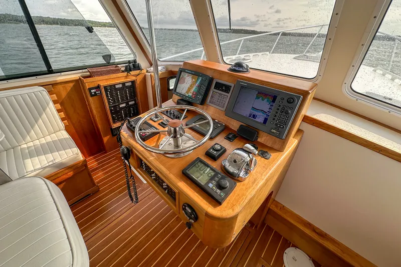 Slide: The Image of Helm of 2003 Northern Bay 36 boat with navigation equipment and wooden interior. - 44