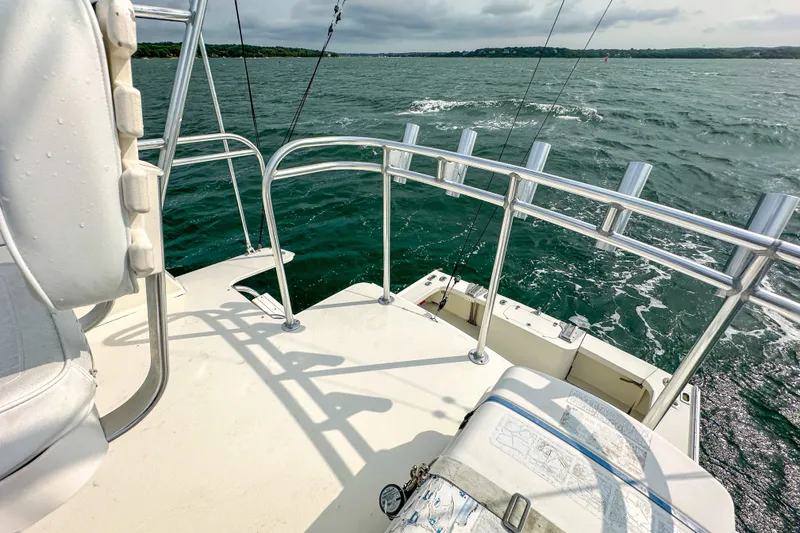 Slide: The Image of Northern Bay 36 boat deck, 2003 model, overlooking calm waters and distant shoreline. - 30
