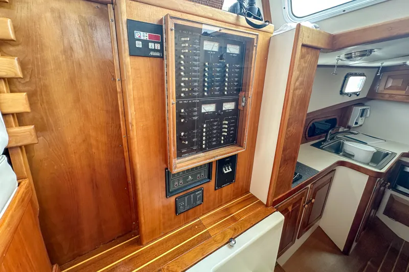 Slide: The Image of 2003 Northern Bay 36 yacht interior with electrical panel and kitchenette. - 46