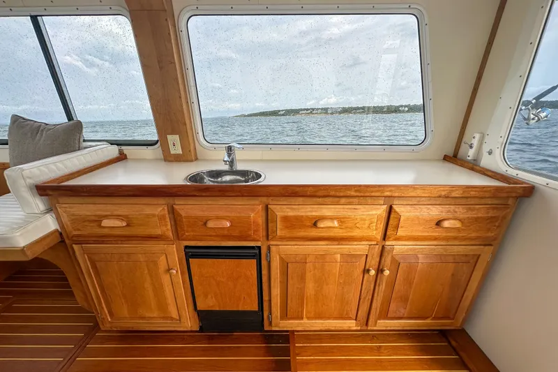 Slide: The Image of Interior of 2003 Northern Bay 36 boat with wooden cabinetry and ocean view. - 37