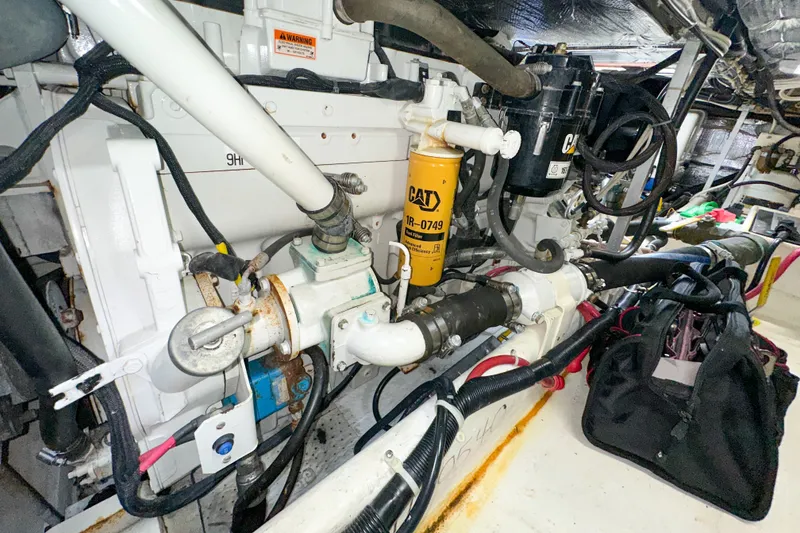 Slide: The Image of Engine room of a 2003 Northern Bay 36 boat, featuring CAT machinery and components. - 59