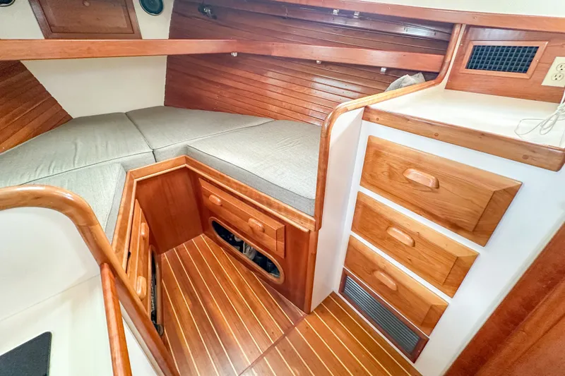 Slide: The Image of Cozy cabin interior of 2003 Northern Bay 36 with wooden finish and storage drawers. - 52