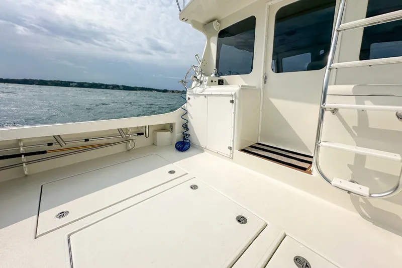 Slide: The Image of 2003 Northern Bay 36 boat deck with ocean view and cabin entrance. - 17