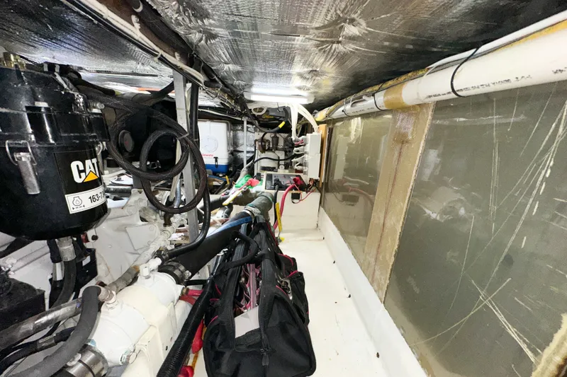 Slide: The Image of Engine room of a 2003 Northern Bay 36 boat, featuring CAT machinery and wiring. - 62