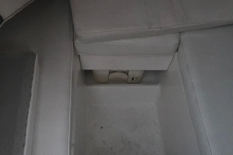 Slide: The Image of Interior view of a 1998 Baha Cruisers 240 WAC boat, featuring cushioned seating. - 16