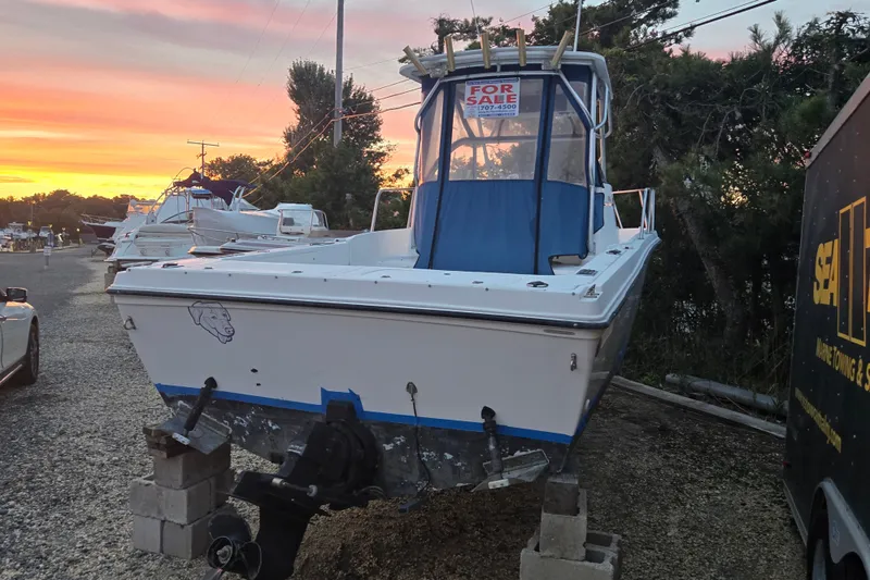 Slide: The Image of 1998 Baha Cruisers 240 WAC boat for sale at sunset, displayed on blocks. - 19