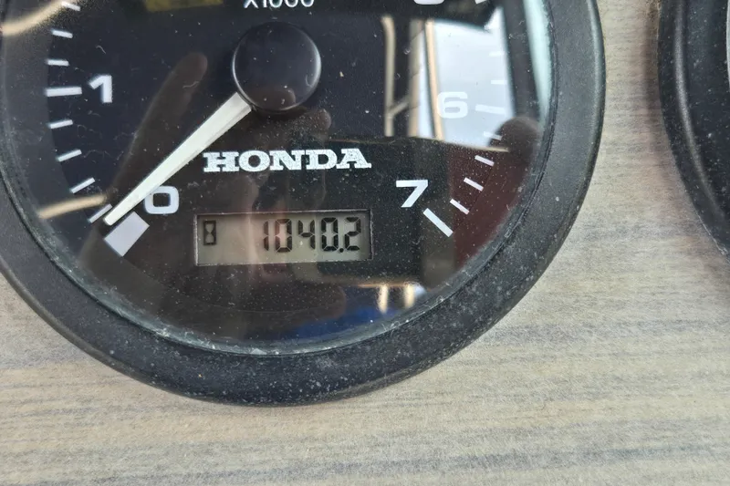 Slide: The Image of Honda tachometer displaying 1040.2 hours on a 1994 Grady-White Adventure 208 boat. - 17