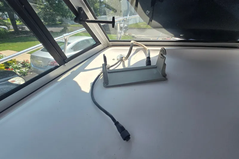 Slide: The Image of Interior view of a 1994 Grady-White Adventure 208 boat, featuring a dashboard with wiring. - 21