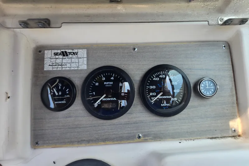 Slide: The Image of Dashboard of a 1994 Grady-White Adventure 208 boat with Honda gauges. - 19
