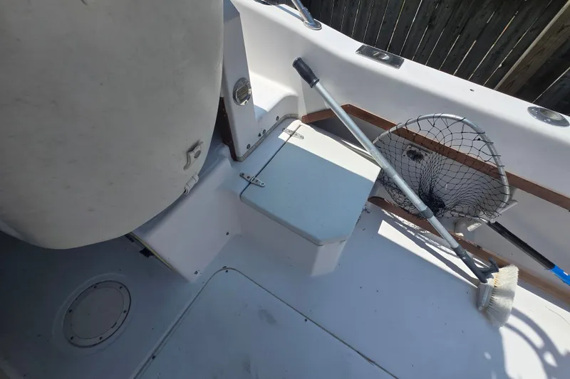 Slide: The Image of Interior of a 1994 Grady-White Adventure 208 boat with fishing gear and cleaning tools. - 15