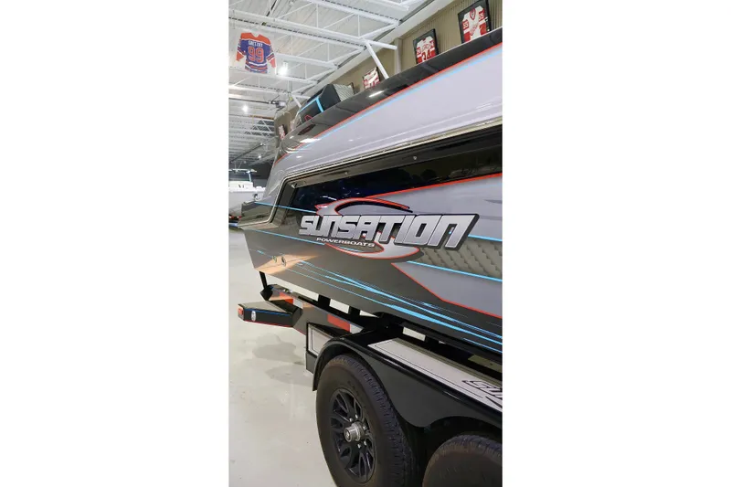 Slide: The Image of 2025 Sunsation 32 CCX powerboat on trailer in showroom. - 7