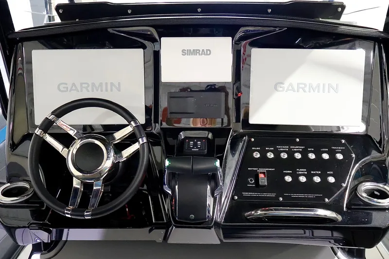 Slide: The Image of 2025 Sunsation 32 CCX dashboard with Garmin displays and Simrad controls. - 29