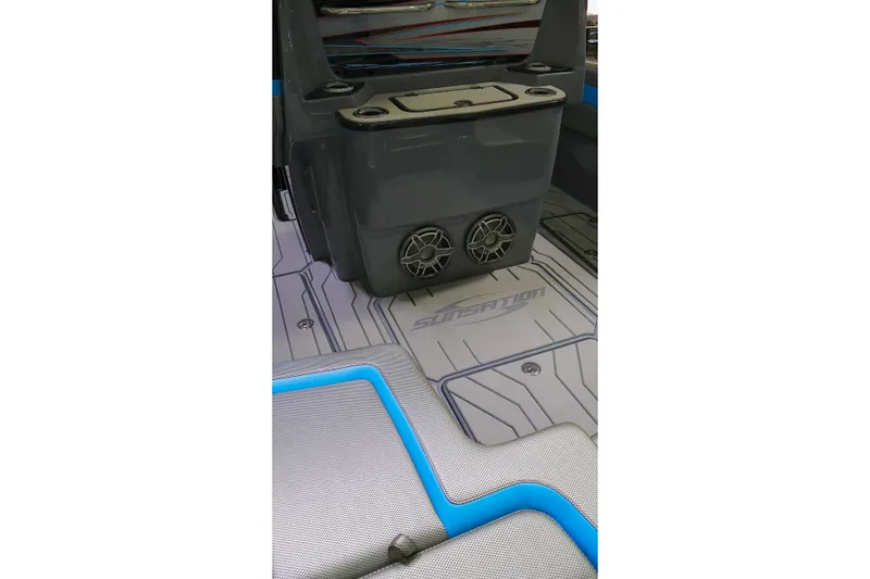 Slide: The Image of 2025 Sunsation 32 CCX boat interior with speakers and branded flooring. - 21