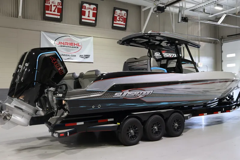 Slide: The Image of 2025 Sunsation 32 CCX boat with powerful outboard motor in a showroom setting. - 8